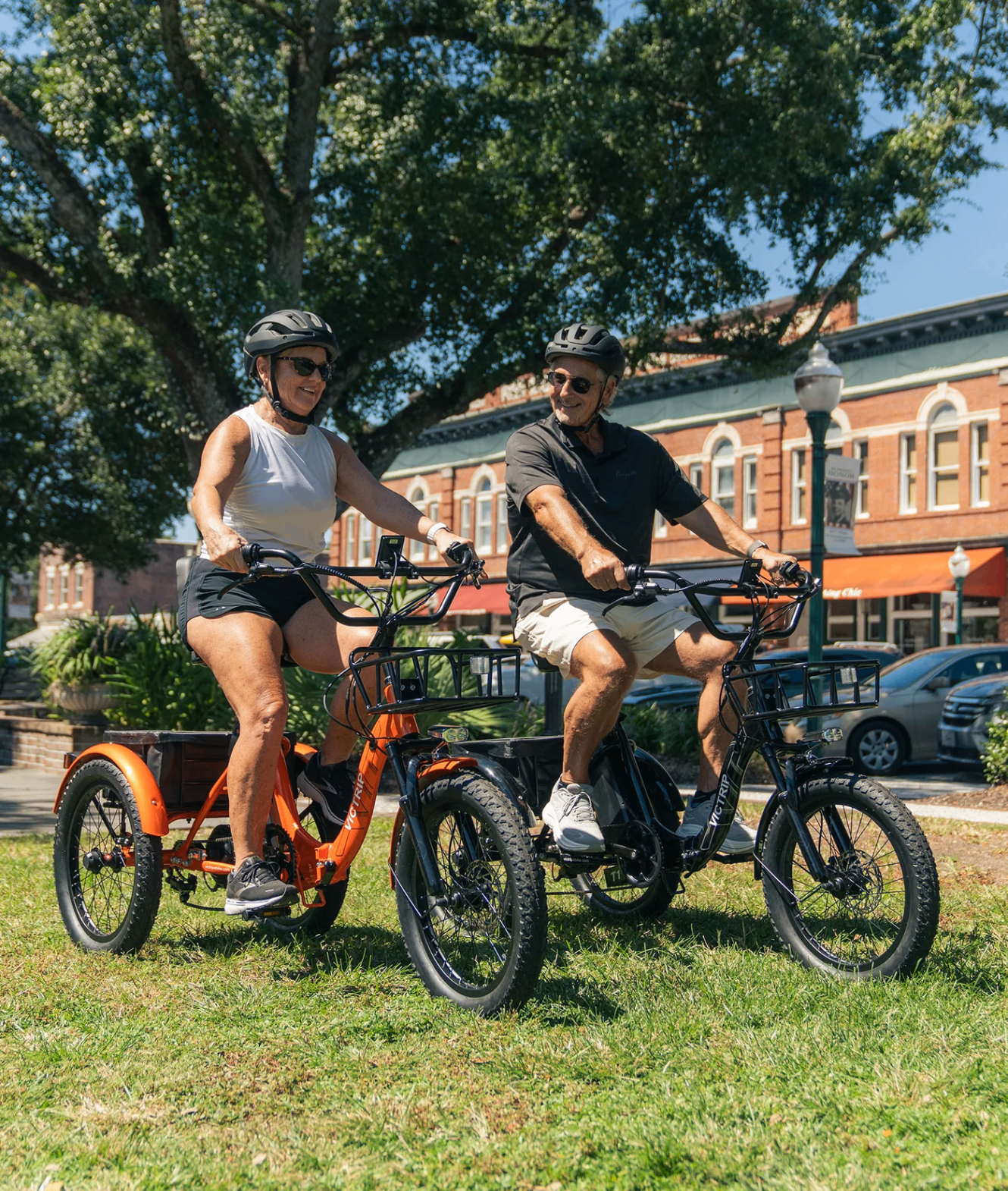 Two riders on VICTRIP folding electric trikes outdoors